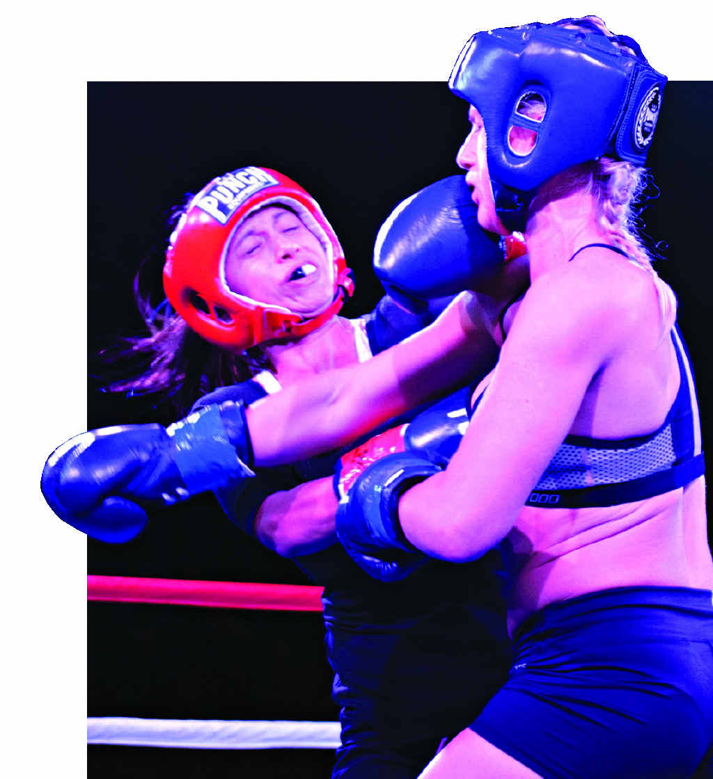 GIRL POWER: Mackay’s Amanda Dick and WMA’s Lauren Candy entertain a strong crowd at Airlie Fight Night IV in their attacking boxing bout. Photo: Keagan Ryan
